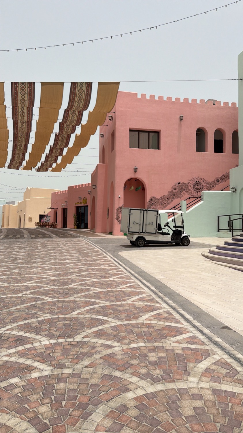 Pink architecture and patterned shade in Doha