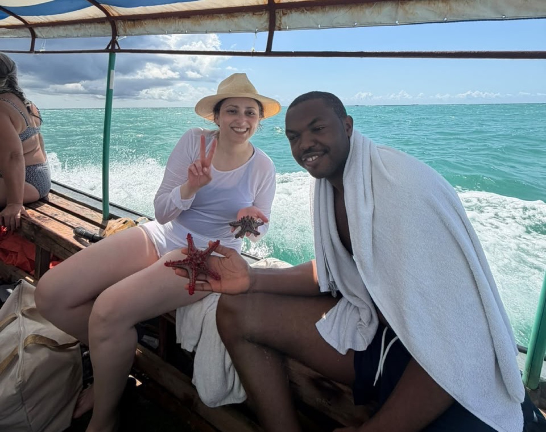 Kenyi hosted trip guests on a boat in clear blue water